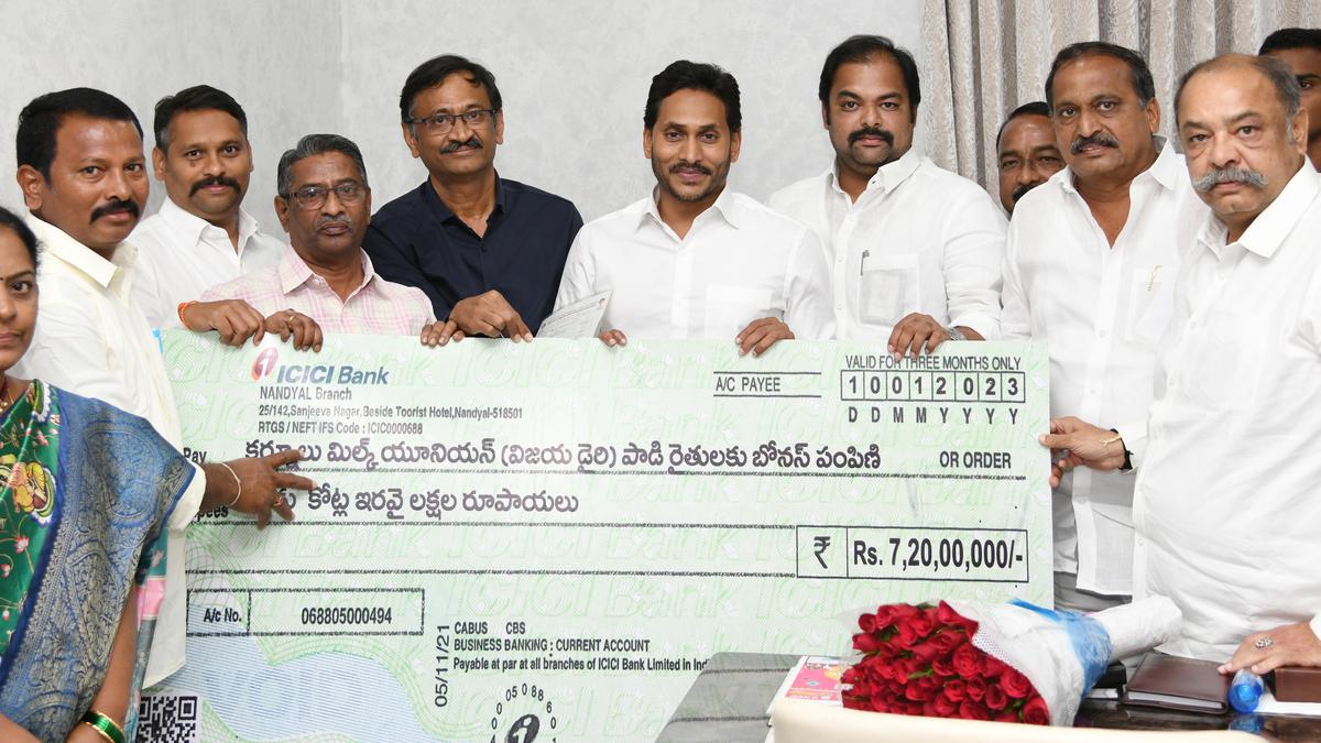 Chief Minister Y.S. Jagan Mohan Reddy handing over the replica of a cheque to the representatives the Kurnool Milk Union at his camp office near Vijayawada on Monday.
